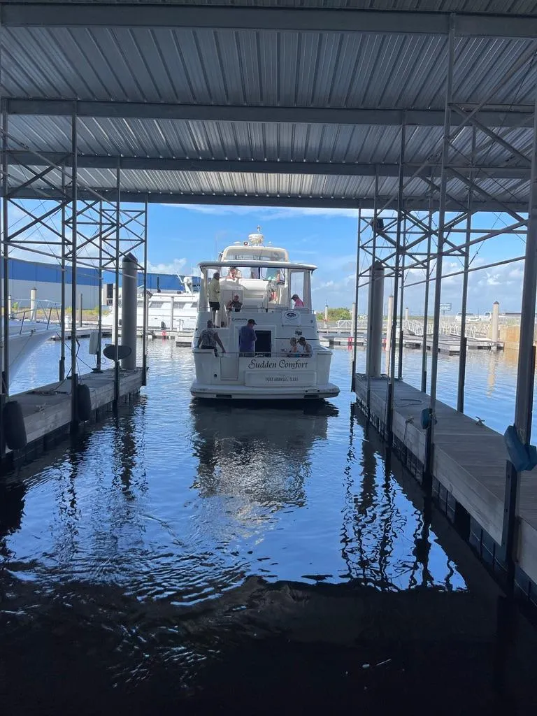 Slide: The Image of 2001 Carver 444 Cockpit Motor Yacht docked in a covered marina. - 8