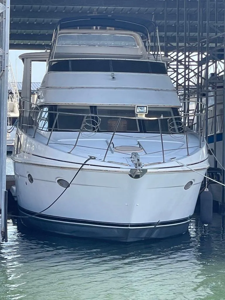 Slide: The Image of 2001 Carver 444 Cockpit Motor Yacht docked in marina. - 9