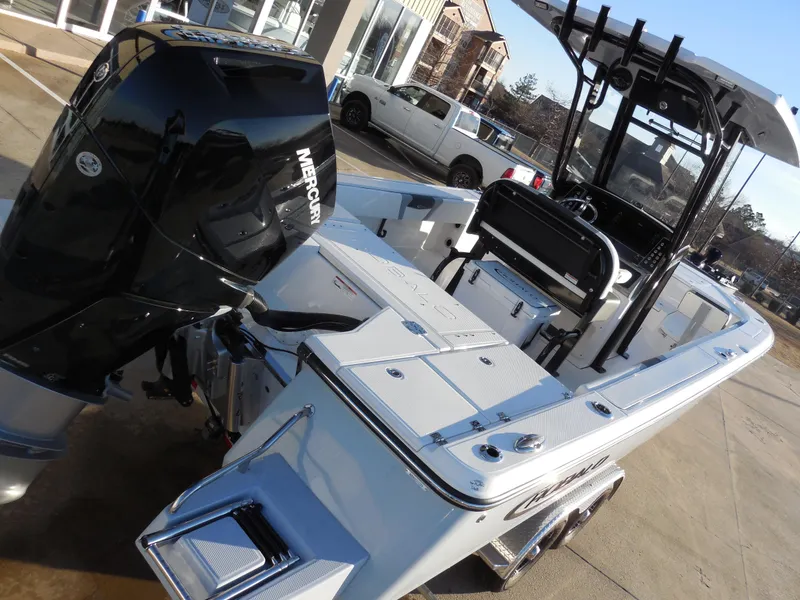 Slide: The Image of 2024 Robalo R266 Cayman boat with Mercury outboard engine, docked at a marina. - 3