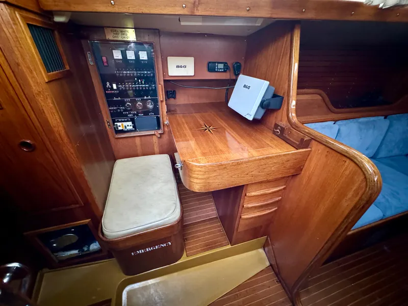 Slide: The Image of 1974 Nautor Swan 38 yacht interior with navigation station and wooden cabinetry. - 11