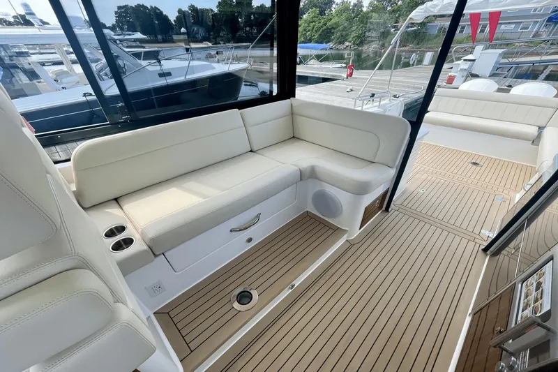 Slide: The Image of 2024 MJM 4 yacht interior with white seating and teak flooring. - 11