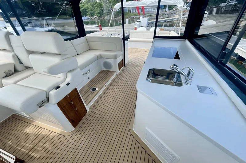 Slide: The Image of Luxurious interior of 2024 MJM 4 yacht with white seating and kitchenette. - 12