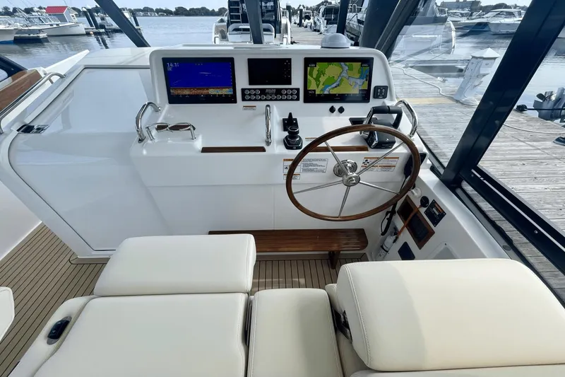 Slide: The Image of Helm of 2024 MJM 4 boat with navigation screens and wooden steering wheel. - 15