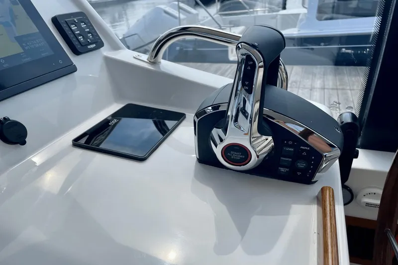 Slide: The Image of 2024 MJM 4 boat control panel with throttle and navigation screen. - 18