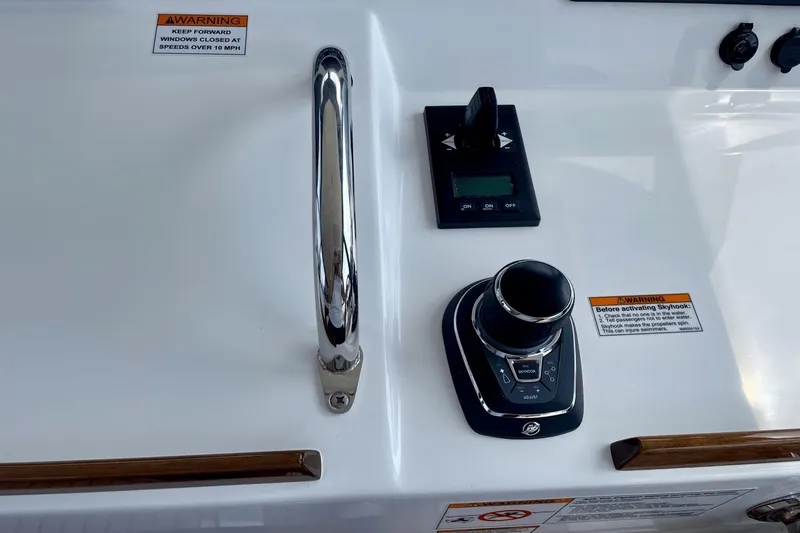 Slide: The Image of Control panel of 2024 MJM 4 boat with joystick and warning labels. - 19