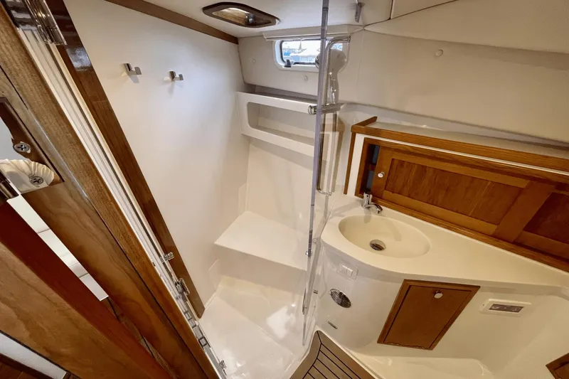 Slide: The Image of 2024 MJM 4 yacht bathroom with wooden accents, shower, and sink. - 26