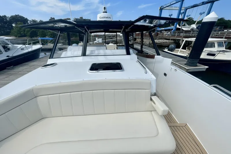 Slide: The Image of 2024 MJM 4 boat with Garmin equipment, docked at a marina. - 31