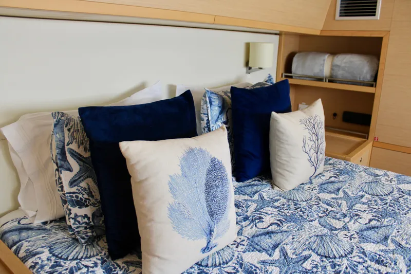 Slide: The Image of Luxurious bedroom in 2015 Lagoon 620 yacht with blue and white nautical-themed bedding. - 10