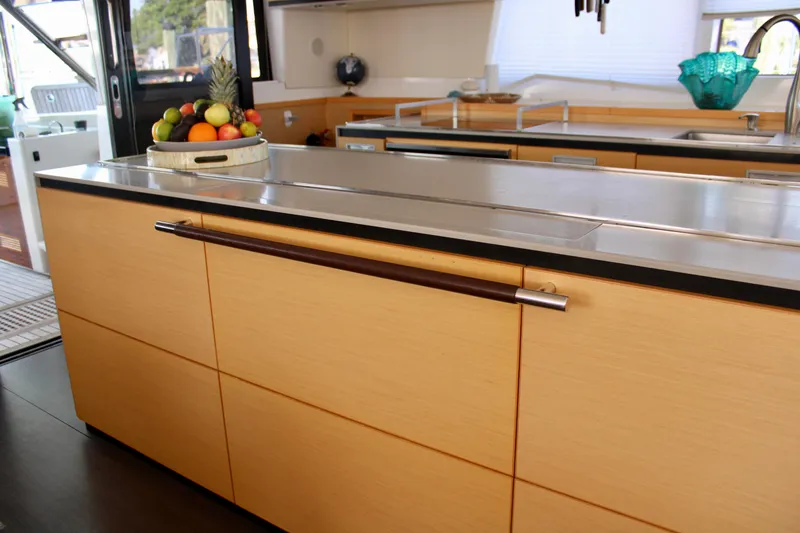Slide: The Image of Modern kitchen interior of 2015 Lagoon 620 yacht with fruit bowl on counter. - 11