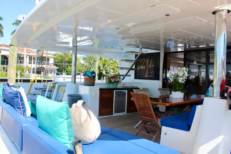 Slide: The Image of Luxurious Lagoon 620 yacht 2015 model with spacious outdoor seating and dining area. - 13