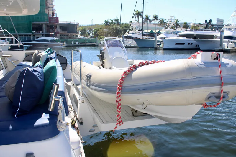 Slide: The Image of Lagoon 620 catamaran with inflatable dinghy docked at marina, 2015 model. - 22