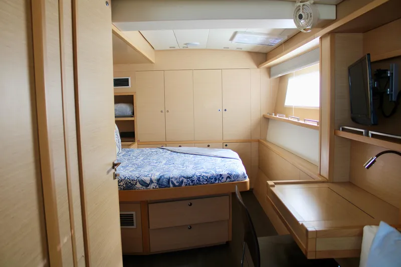 Slide: The Image of Luxurious cabin interior of 2015 Lagoon 620 yacht with bed, desk, and storage. - 23