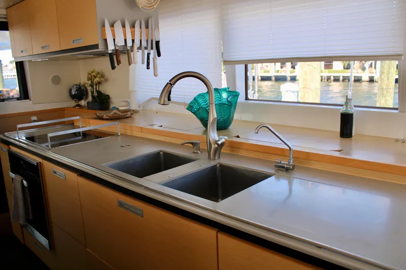Slide: The Image of Modern kitchen in 2015 Lagoon 620 catamaran with dual sinks and stainless steel countertops. - 24