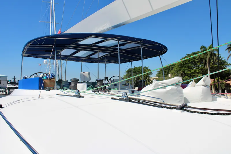 Slide: The Image of Lagoon 620 catamaran 2015 model with blue canopy, docked at marina. - 28