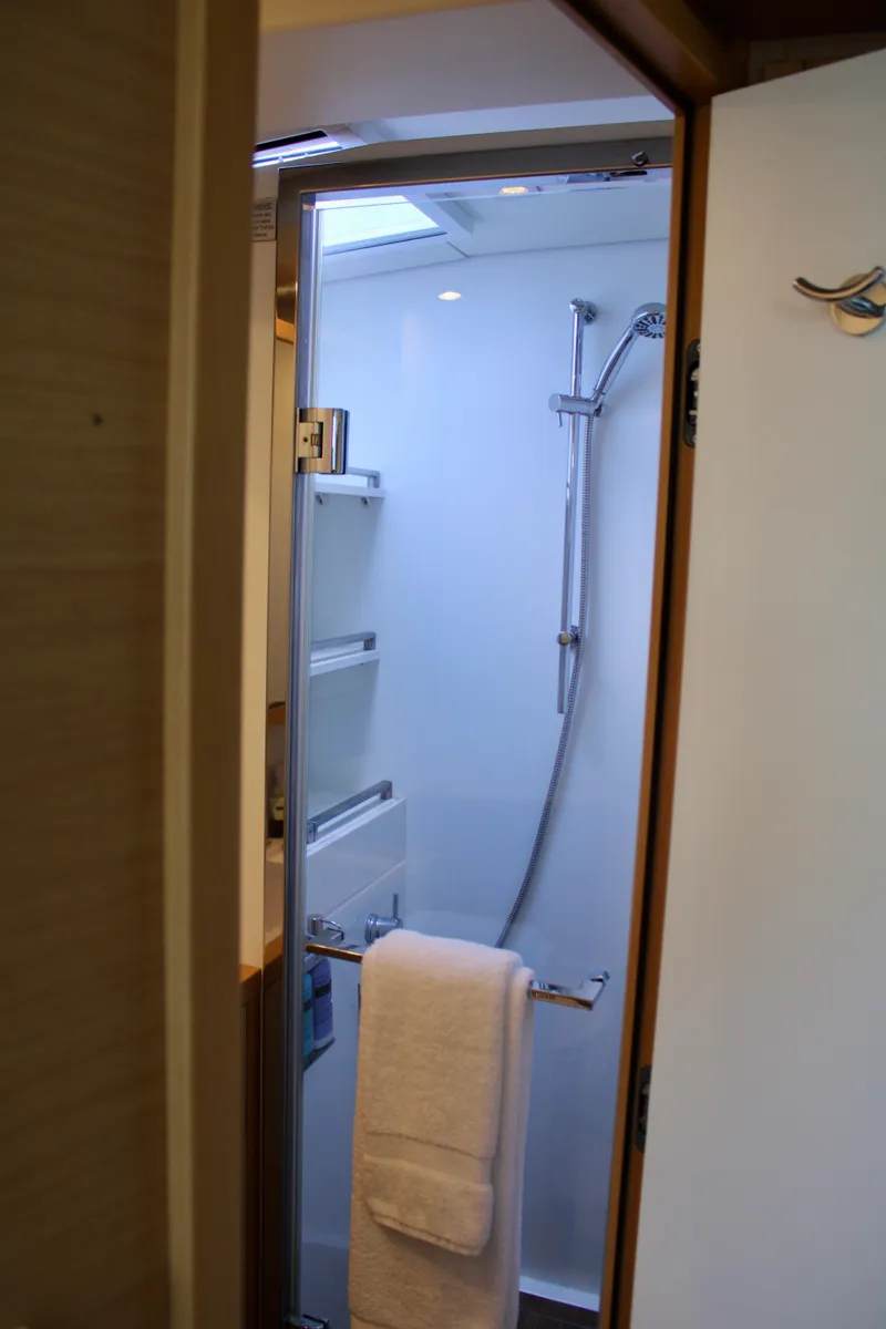 Slide: The Image of Modern shower area in 2015 Lagoon 620 yacht with towel and glass door. - 29