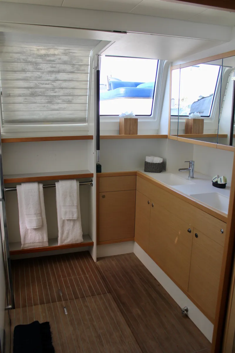 Slide: The Image of Modern bathroom in 2015 Lagoon 620 catamaran with wooden accents and ample natural light. - 41