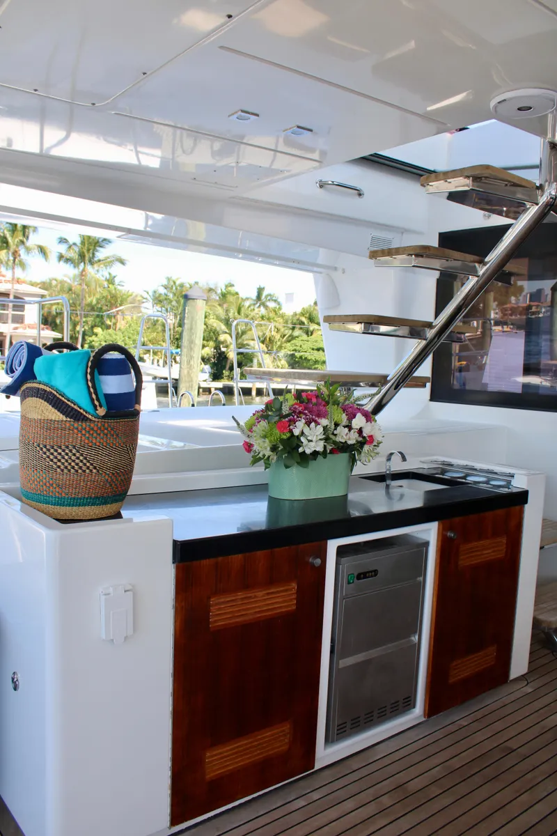 Slide: The Image of Outdoor kitchen area on a 2015 Lagoon 620 yacht with flowers and a basket. - 44