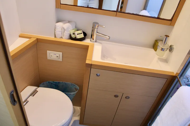 Slide: The Image of Modern bathroom in 2015 Lagoon 620 yacht with sink, toilet, and storage cabinets. - 47