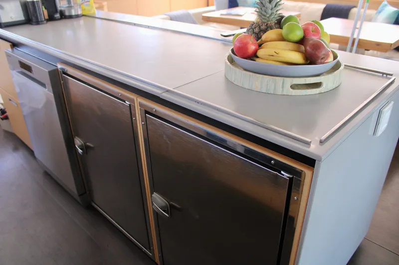 Slide: The Image of Modern kitchen counter with stainless steel appliances on a 2015 Lagoon 620 yacht. - 48