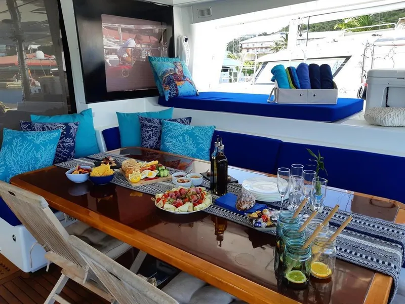 Slide: The Image of Luxurious dining setup on Lagoon 620 yacht, 2015 model, with gourmet food and elegant decor. - 6