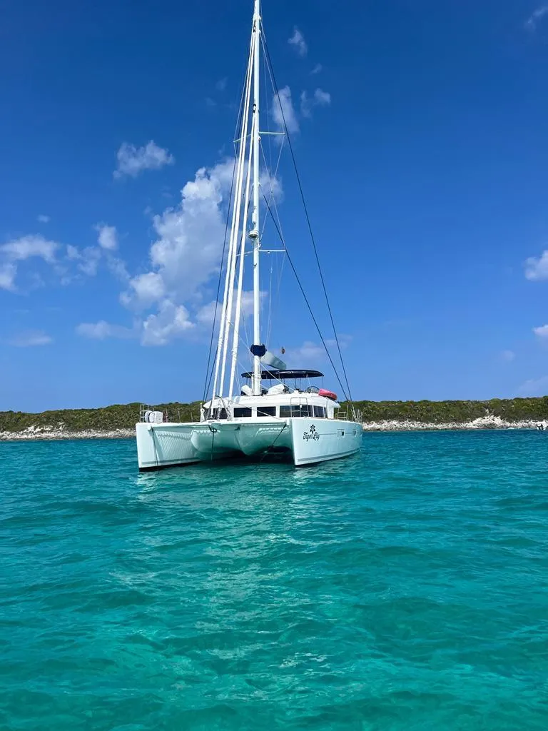Slide: The Image of Lagoon 620 catamaran sailing in clear turquoise waters, 2015 model. - 8