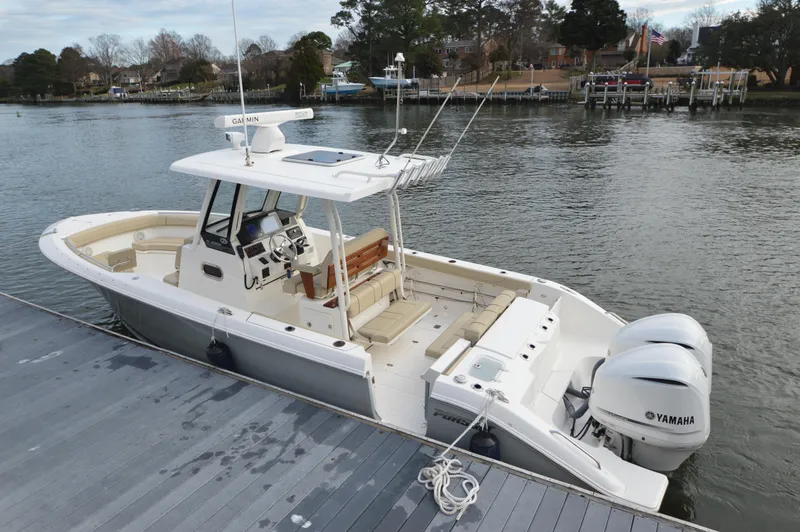 Slide: The Image of 2019 Pursuit S 288 Sport boat docked with twin Yamaha engines. - 10