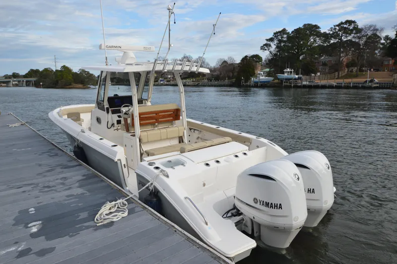 Slide: The Image of 2019 Pursuit S 288 Sport boat docked with twin Yamaha engines. - 12