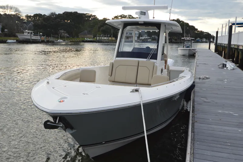 Slide: The Image of 2019 Pursuit S 288 Sport boat docked by the pier on a calm waterway. - 13