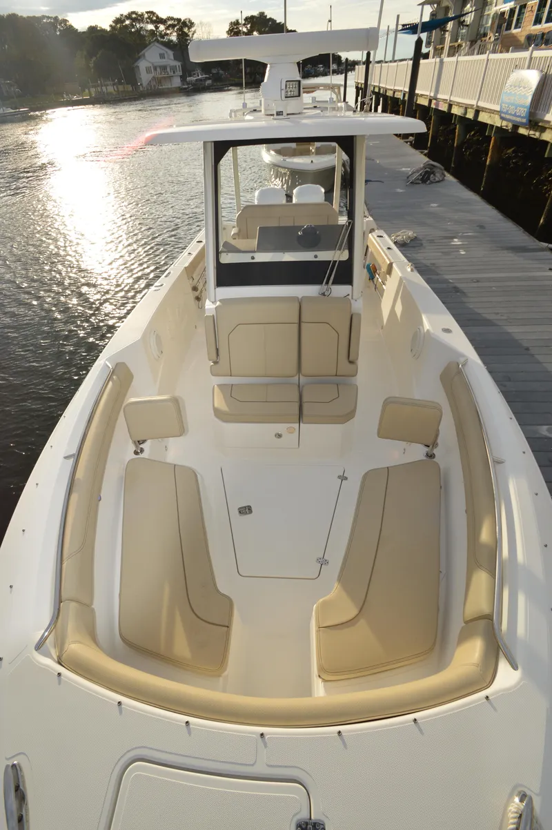 Slide: The Image of 2019 Pursuit S 288 Sport boat docked, featuring spacious seating and sleek design. - 16