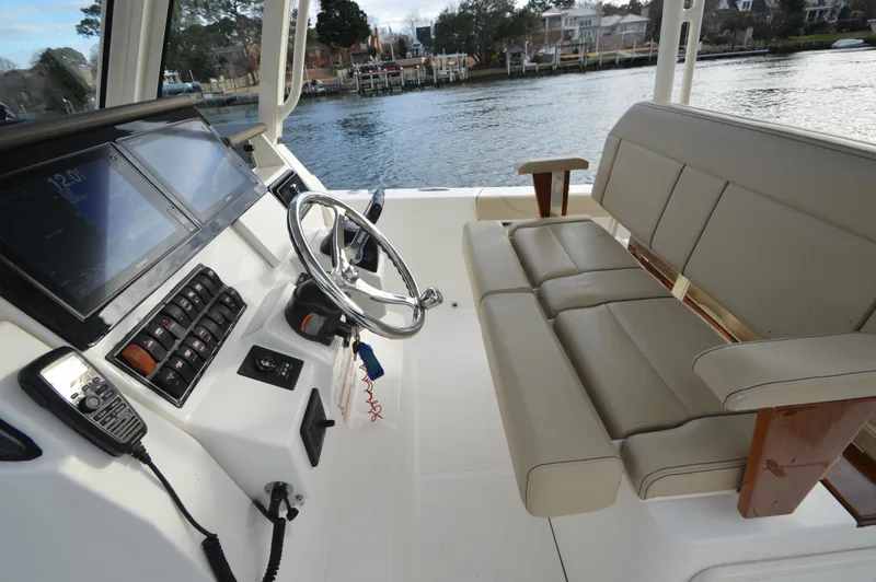 Slide: The Image of 2019 Pursuit S 288 Sport boat interior with steering wheel and seating. - 18