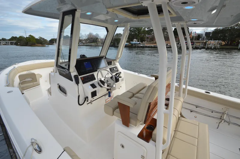 Slide: The Image of 2019 Pursuit S 288 Sport boat interior with helm and seating. - 19