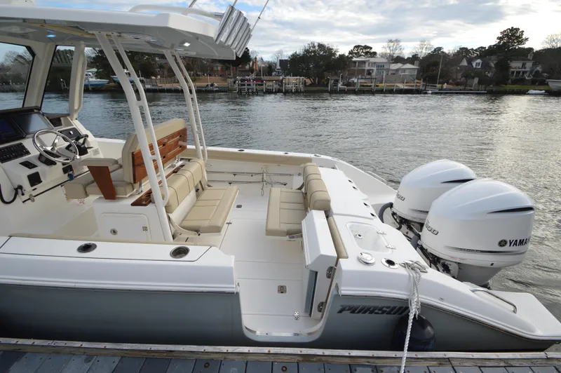 Slide: The Image of 2019 Pursuit S 288 Sport boat with Yamaha engines docked by the water. - 20