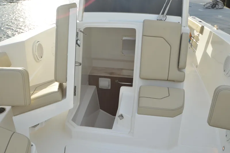 Slide: The Image of Interior view of 2019 Pursuit S 288 Sport boat with beige seating and cabin entrance. - 22
