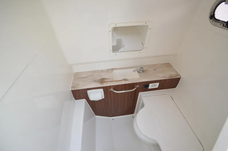 Slide: The Image of 2019 Pursuit S 288 Sport boat interior bathroom with sink and toilet. - 23