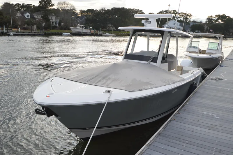 Slide: The Image of 2019 Pursuit S 288 Sport boat docked by the waterfront. - 26