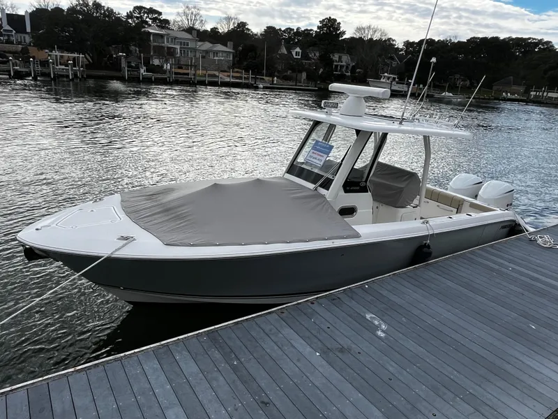 Slide: The Image of 2019 Pursuit S 288 Sport boat docked by the waterfront. - 29