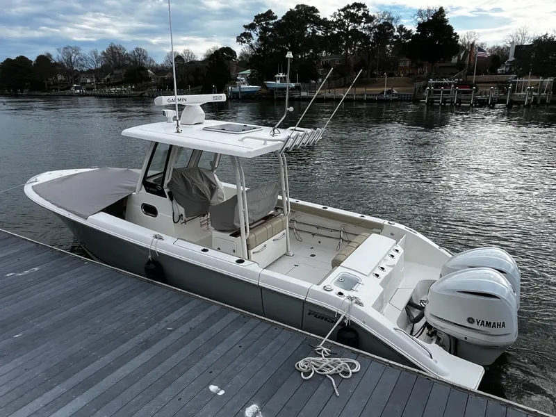 Slide: The Image of 2019 Pursuit S 288 Sport boat docked with twin Yamaha engines. - 30