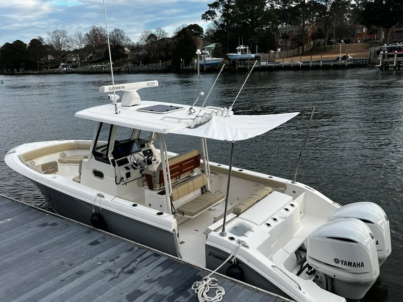 Slide: The Image of 2019 Pursuit S 288 Sport boat docked with twin Yamaha engines. - 31