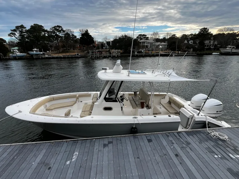 Slide: The Image of 2019 Pursuit S 288 Sport boat docked by the waterfront. - 32