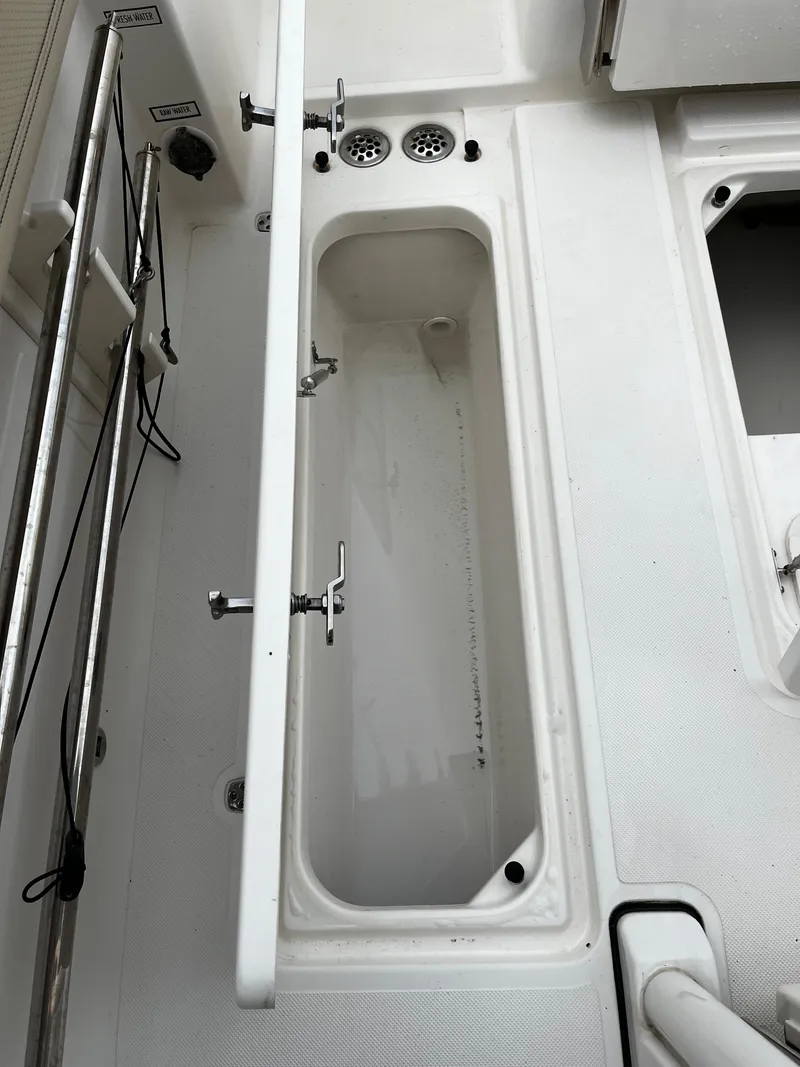 Slide: The Image of 2019 Pursuit S 288 Sport boat storage compartment with fresh and raw water outlets. - 34
