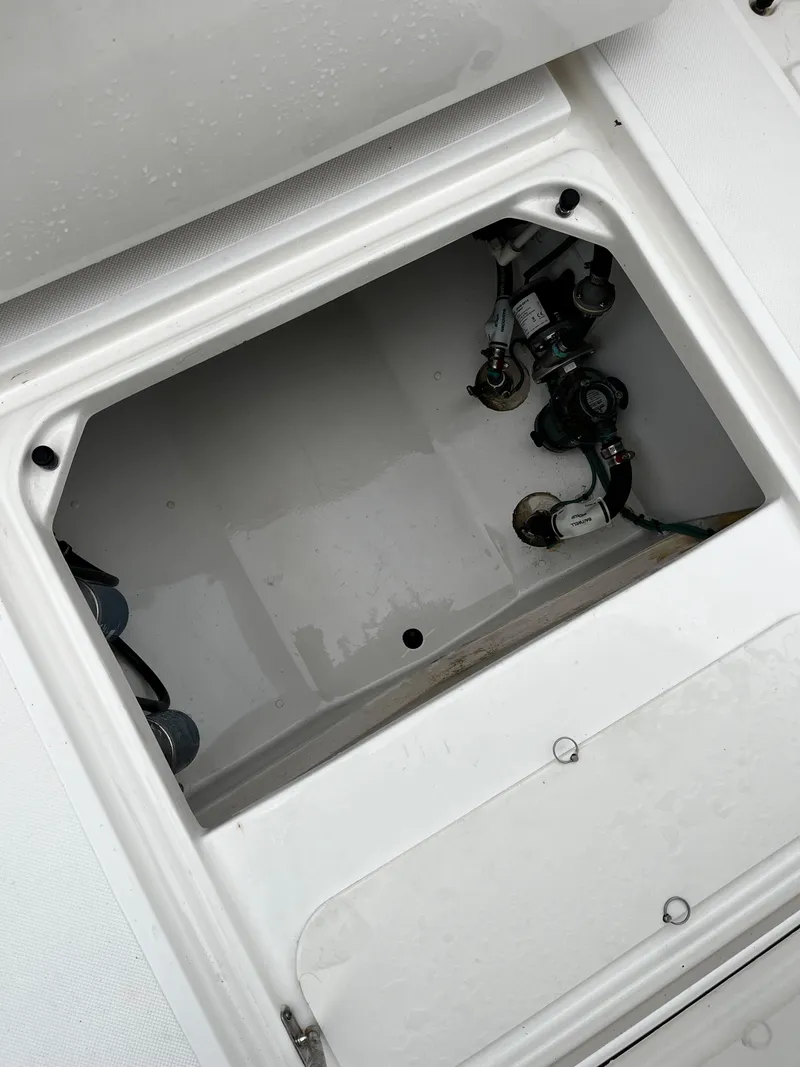 Slide: The Image of Open hatch of a 2019 Pursuit S 288 Sport boat showing internal components. - 35