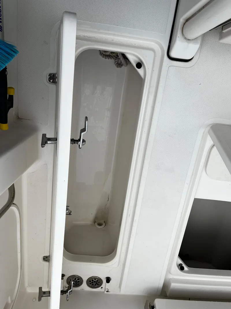 Slide: The Image of Open storage compartment on a 2019 Pursuit S 288 Sport boat. - 37