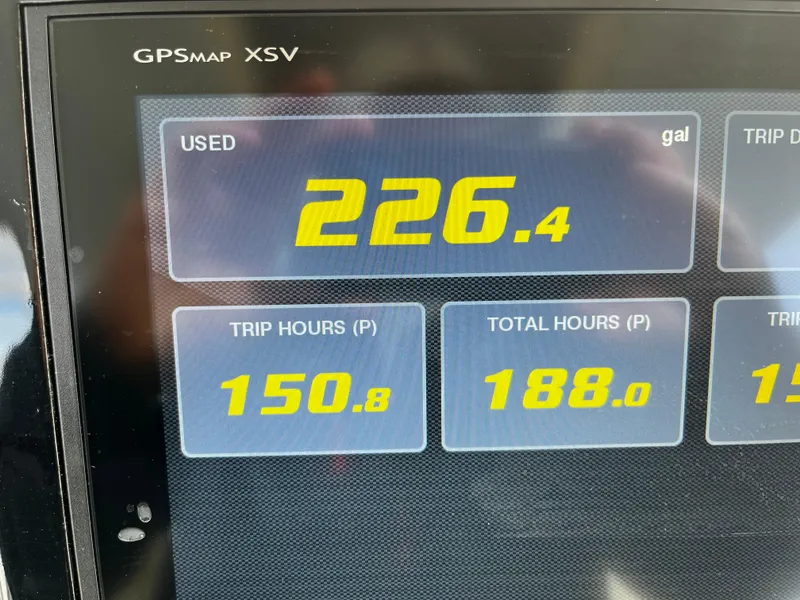 Slide: The Image of GPS display showing fuel usage and trip hours on a 2019 Pursuit S 288 Sport boat. - 39