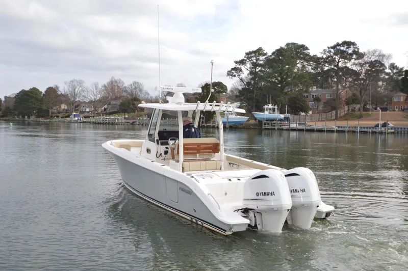 Slide: The Image of 2019 Pursuit S 288 Sport boat with twin Yamaha engines on a calm waterway. - 4