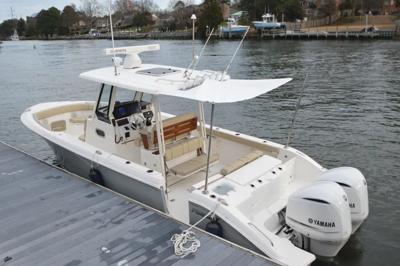 Slide: The Image of 2019 Pursuit S 288 Sport boat docked with twin Yamaha engines. - 7