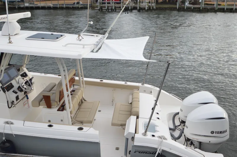 Slide: The Image of 2019 Pursuit S 288 Sport boat with Yamaha engines docked on water. - 8