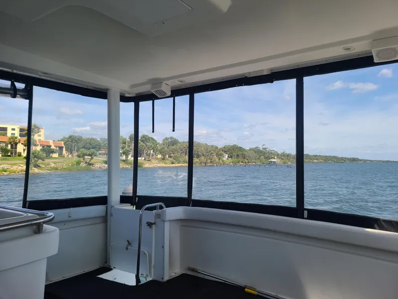 Slide: The Image of View from 1997 Silverton 372 Motor Yacht, overlooking serene waterfront and distant shoreline. - 14