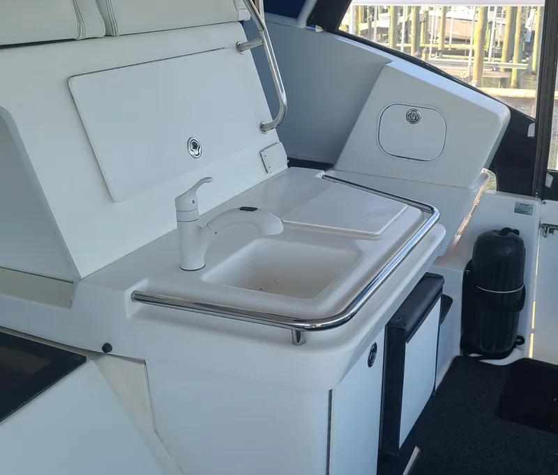 Slide: The Image of 1997 Silverton 372 Motor Yacht interior with sink and storage area. - 16