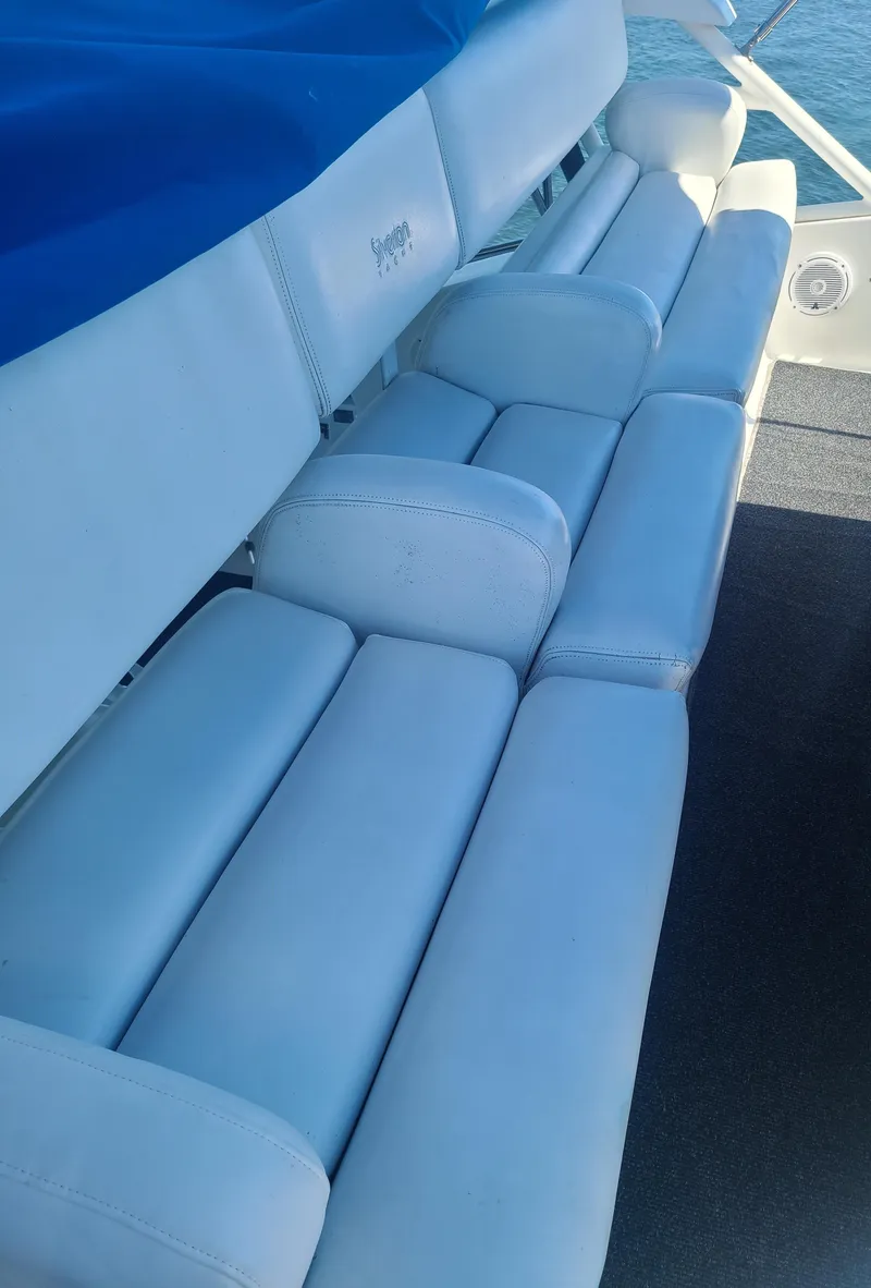 Slide: The Image of White cushioned seating on a 1997 Silverton 372 Motor Yacht, with blue cover. - 20