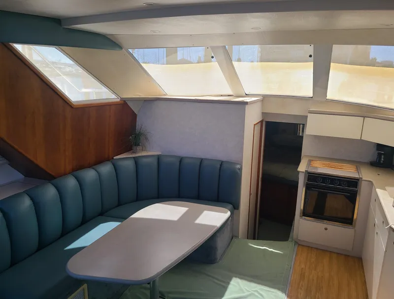Slide: The Image of Interior of 1997 Silverton 372 Motor Yacht with seating and kitchen area. - 4